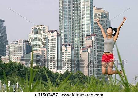 Stock Photo - Young Adult, Young Men, Young Women, Outdoors, Sports Clothing, Athletic, Healthy Lifestyle. Fotosearch
