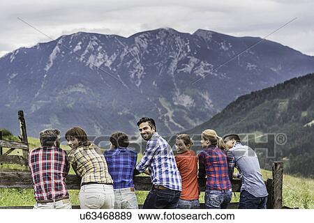 Back view of group of friends enjoying view, Tirol, Austria View Large Photo Image Stock Photo - Back view of group of friends enjoying view, Tirol, Austria. Fotosearch