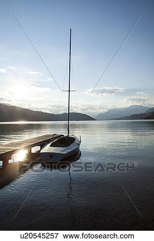 Stock Photo - Boat on lake with mountains in background, Carinthia, Austria. Fotosearch