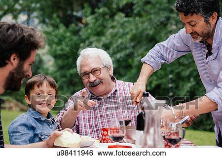 Boy and grandfather at family meal View Large Photo Image Stock Photograph - Boy and grandfather at family meal. Fotosearch