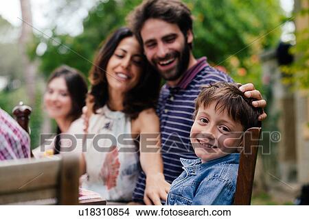 Boy and parents at outdoor family meal View Large Photo Image Picture - Boy and parents at outdoor family meal. Fotosearch