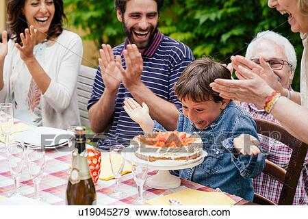 Boy being surprised with birthday cake View Large Photo Image Stock Photo - Boy being surprised with birthday cake. Fotosearch