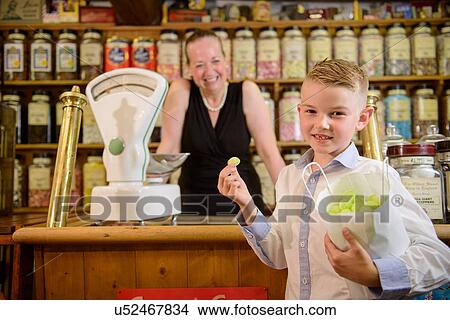 Boy holding bag of confectionery View Large Photo Image Picture - Boy holding bag of confectionery. Fotosearch