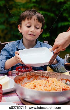 Boy waiting to be served spaghetti View Large Photo Image Stock Photograph - Boy waiting to be served spaghetti. Fotosearch