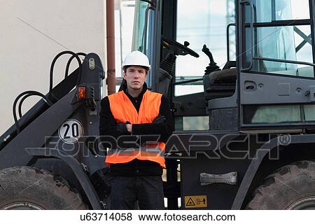 Builder standing in front of truck View Large Photo Image Stock Photo - Builder standing in front of truck. Fotosearch