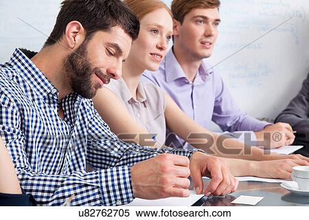 Stock Photography - Business colleagues in meeting. Fotosearch