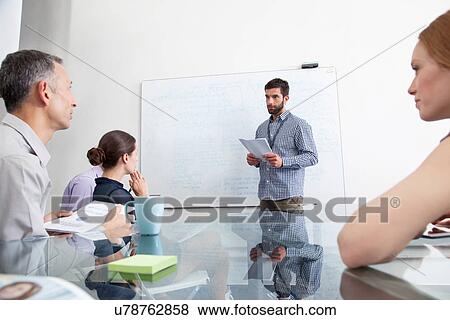 Businessman presenting to colleagues View Large Photo Image Stock Photo - Businessman presenting to colleagues. Fotosearch