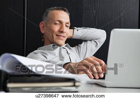 Businessman using laptop View Large Photo Image Stock Photo - Businessman using laptop. Fotosearch