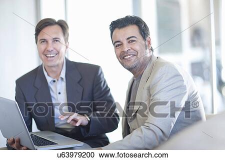 Businesspeople using laptop View Large Photo Image Stock Image - Businesspeople using laptop. Fotosearch
