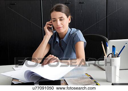 Stock Image - Businesswoman on cell phone. Fotosearch