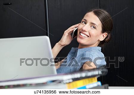 Stock Photograph - Businesswoman on smart phone. Fotosearch