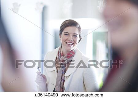 Businesswoman standing in office View Large Photo Image Stock Image - Businesswoman standing in office. Fotosearch
