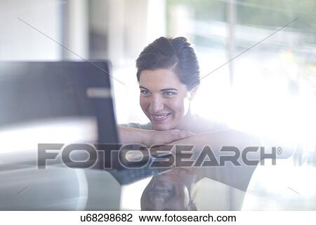 Businesswoman using laptop computer View Large Photo Image Stock Image - Businesswoman using laptop computer. Fotosearch