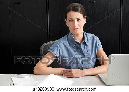 Stock Image - Businesswoman using laptop. Fotosearch