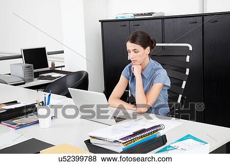 Businesswoman using latop View Large Photo Image Stock Photo - Businesswoman using latop. Fotosearch