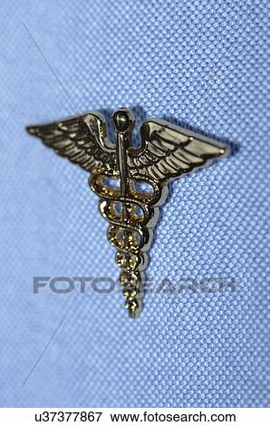 Stock Photo - Caduceus pin attached to a shirt. Fotosearch