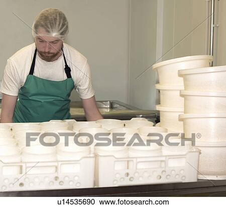 Cheesemaker with plastic containers at farm factory View Large Photo Image Stock Image - Cheesemaker with plastic containers at farm factory. Fotosearch