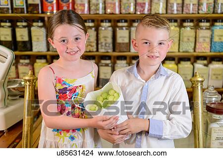 Picture - Children holding bag of confectionery. Fotosearch