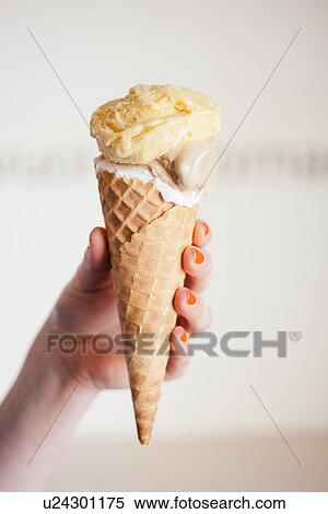 Close up of female hand holding ice cream cone View Large Photo Image Stock Photography - Close up of female hand holding ice cream cone. Fotosearch