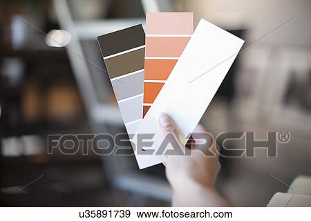Close up of female hand holding up swatches View Large Photo Image Stock Photo - Close up of female hand holding up swatches. Fotosearch