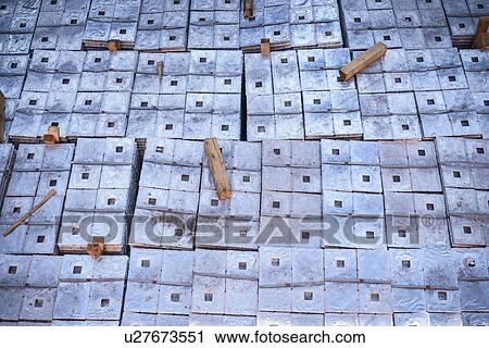 Stock Image - Close up of metal alloy cargo in ship's hold. Fotosearch