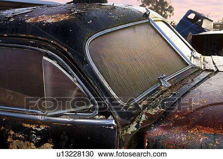 Close up of vintage car in scrap yard View Large Photo Image Stock Image - Close up of vintage car in scrap yard. Fotosearch