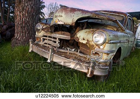 Stock Photography - Close up of vintage car in scrap yard. Fotosearch