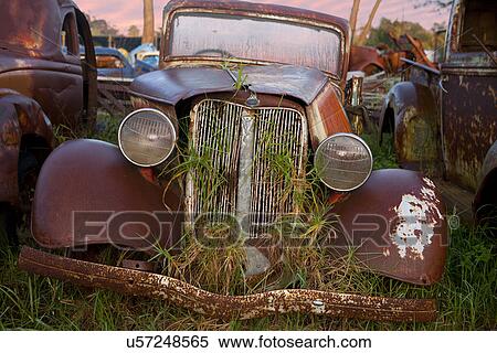 Stock Photography - Close up of vintage car in scrap yard. Fotosearch