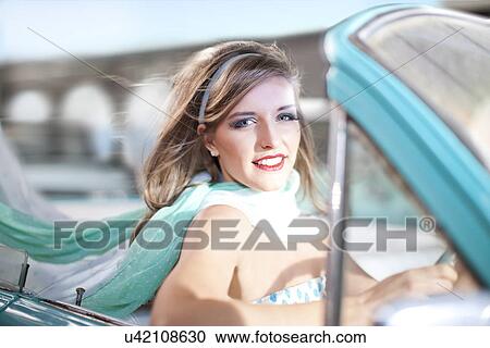 Close up of woman driving vintage convertible View Large Photo Image Stock Image - Close up of woman driving vintage convertible. Fotosearch