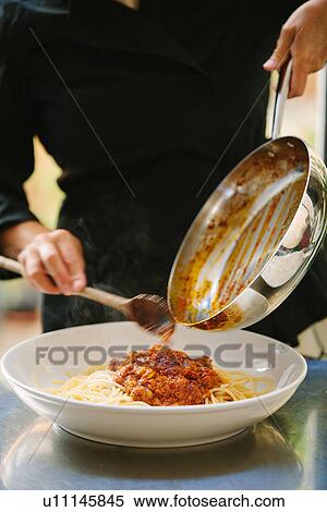 Close up of woman scraping bolognese sauce from pan to plate View Large Photo Image Stock Photography - Close up of woman scraping bolognese sauce from pan to plate. Fotosearch