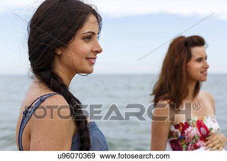 Stock Photo - Close up of women on beach. Fotosearch