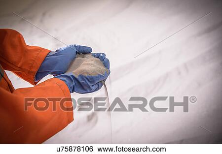 Close up of worker holding zircon sand View Large Photo Image Stock Photograph - Close up of worker holding zircon sand. Fotosearch