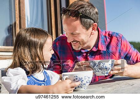 Stock Photography - Close up portrait of father and daughter outside chalet, Tyrol, Austria. Fotosearch