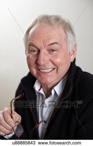 Close up portrait of senior man holding spectacles View Large Photo Image Stock Image - Close up portrait of senior man holding spectacles. Fotosearch
