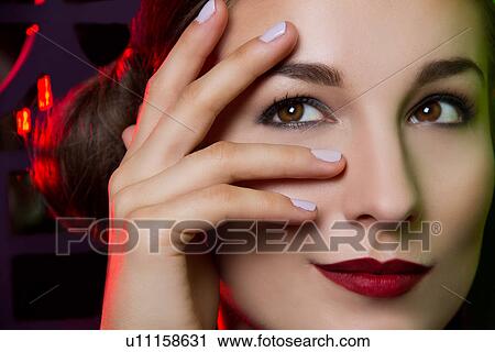 Close up portrait of smiling young woman with hand on face View Large Photo Image Stock Image - Close up portrait of smiling young woman with hand on face. Fotosearch