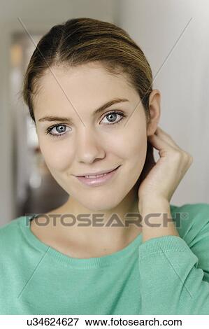 Close up portrait of young woman with hand in hair View Large Photo Image Stock Photo - Close up portrait of young woman with hand in hair. Fotosearch