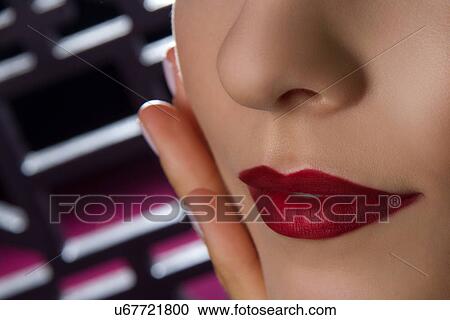Stock Image - Close up studio portrait of young woman's lips. Fotosearch