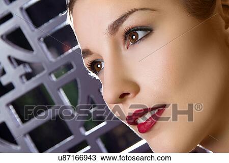 Stock Image - Close up studio portrait of young woman. Fotosearch