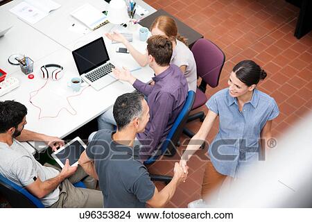 Colleagues shaking hands, high angle View Large Photo Image Picture - Colleagues shaking hands, high angle. Fotosearch