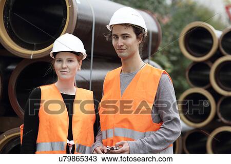 Construction workers standing in front of pipes View Large Photo Image Stock Image - Construction workers standing in front of pipes. Fotosearch