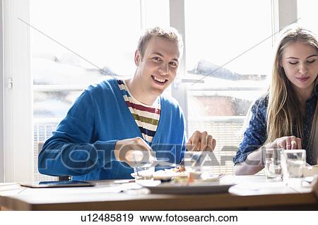 Stock Photo - Couple eating meal. Fotosearch