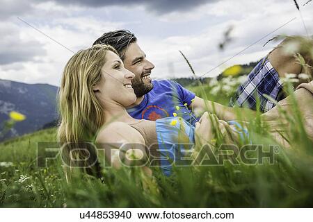 Couple enjoying the meadow View Large Photo Image Stock Image - Couple enjoying the meadow. Fotosearch