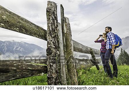 Couple enjoying view through binoculars, Tirol, Austria View Large Photo Image Stock Image - Couple enjoying view through binoculars, Tirol, Austria. Fotosearch