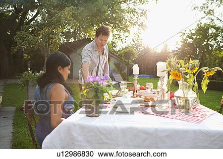 Couple having dinner in garden View Large Photo Image Stock Image - Couple having dinner in garden. Fotosearch