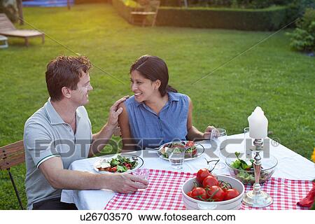 Couple having dinner in garden View Large Photo Image Stock Image - Couple having dinner in garden. Fotosearch