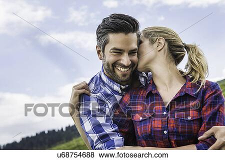 Stock Photo - Couple hugging and kissing. Fotosearch