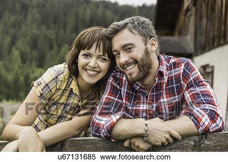 Couple leaning on wooden fence View Large Photo Image Stock Photography - Couple leaning on wooden fence. Fotosearch