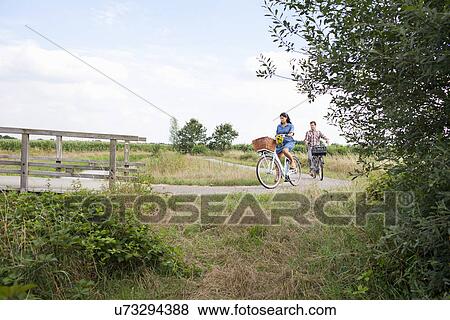 Stock Photo - Couple out for bike ride. Fotosearch