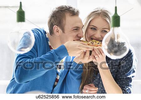 Couple sharing pizza View Large Photo Image Stock Photograph - Couple sharing pizza. Fotosearch