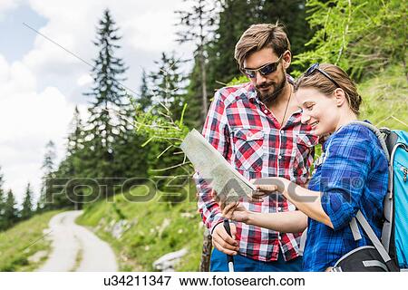 Stock Photo - Couple with map, Tyrol, Austria. Fotosearch